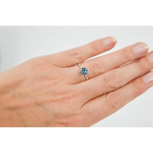 93 - A 14ct white gold and blue topaz and diamond ring, size M, 1.6g.