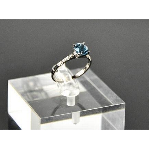 93 - A 14ct white gold and blue topaz and diamond ring, size M, 1.6g.