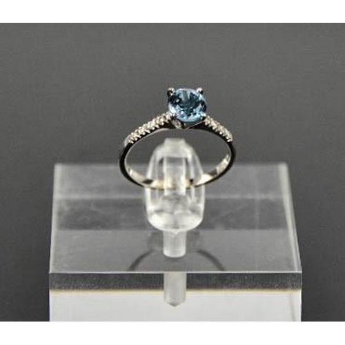 93 - A 14ct white gold and blue topaz and diamond ring, size M, 1.6g.
