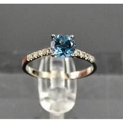 93 - A 14ct white gold and blue topaz and diamond ring, size M, 1.6g.