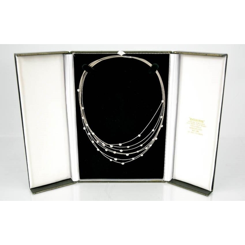 95 - An 18ct white gold, seven strand diamond set necklace, with thirty five individual collet set diamon... 