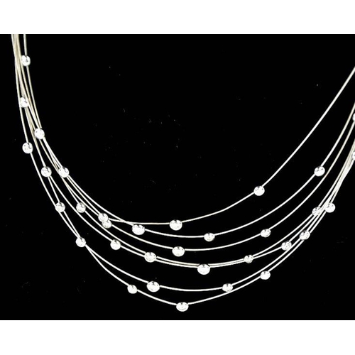 95 - An 18ct white gold, seven strand diamond set necklace, with thirty five individual collet set diamon... 