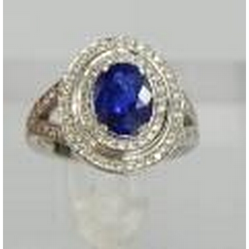 98 - An 18ct white gold and sapphire ring, the sapphire approximately 2ct, bordered by two rows of diamon... 