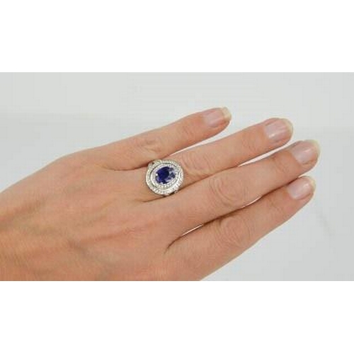 98 - An 18ct white gold and sapphire ring, the sapphire approximately 2ct, bordered by two rows of diamon... 