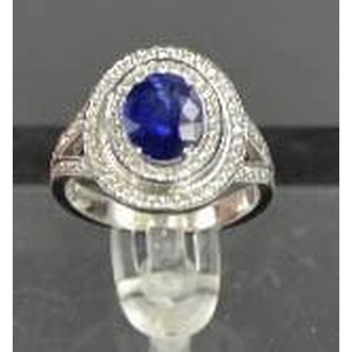 98 - An 18ct white gold and sapphire ring, the sapphire approximately 2ct, bordered by two rows of diamon... 