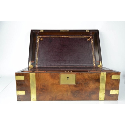 44 - A 19th century campaign style burr walnut writing box with leather clad slope, with key and secret d... 
