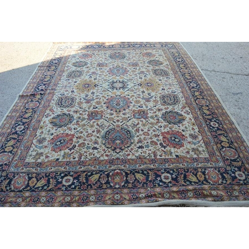 484 - A large carpet in blue, pink and cream 350 by 300cm.