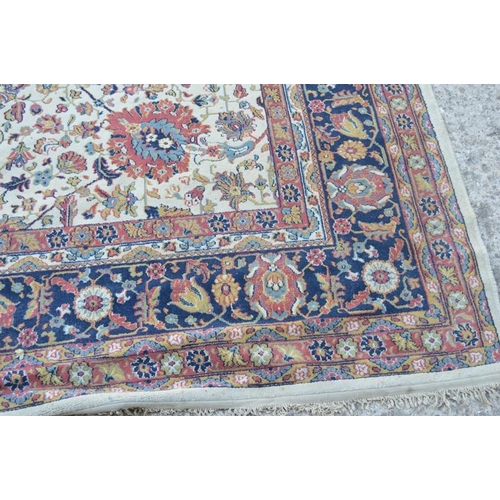 484 - A large carpet in blue, pink and cream 350 by 300cm.