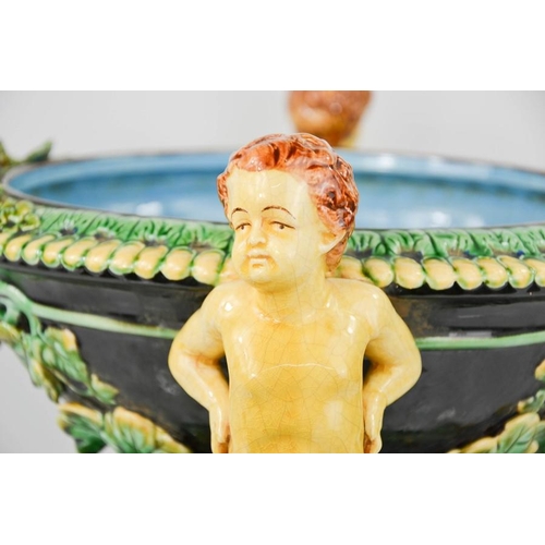 5 - A 20th century majolica jardinere with cherub head handles interspersed with rams heads,.