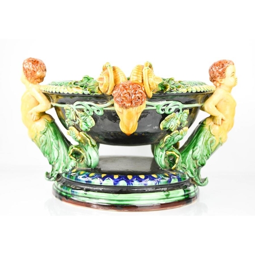 5 - A 20th century majolica jardinere with cherub head handles interspersed with rams heads,.