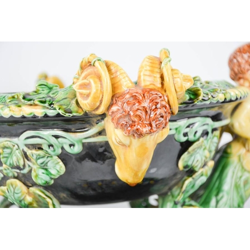 5 - A 20th century majolica jardinere with cherub head handles interspersed with rams heads,.