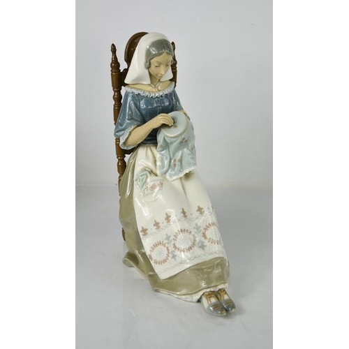 100 - A large Lladro figurine titled Embroiderer, lady sewing, 4865, 24cm high.