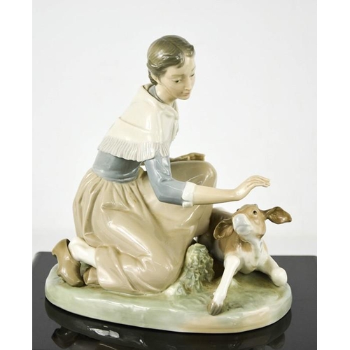 108 - A Lladro porcelain group titled Caressing a Little Calf, number 4827, 18cm high.