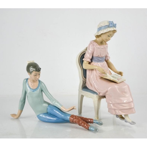 128 - Two Lladro porcelain figurines: Ballerina, and lady seated reading a book, 24cm high.