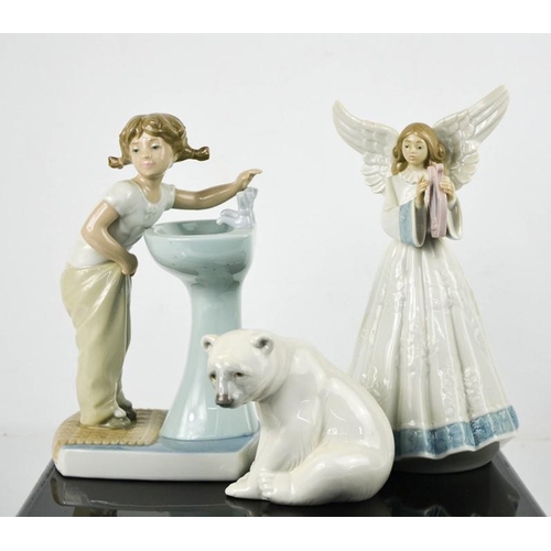 130 - Three Lladro porcelain figurines: Polar Bear Cub, Angel and Clean up Girl number 4838, 20cm high.