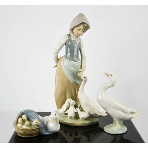 131 - Three Lladro porcelain figurines: Girl Feeding Ducks, Duck, and Mother Duck with Chicks in Basket nu... 