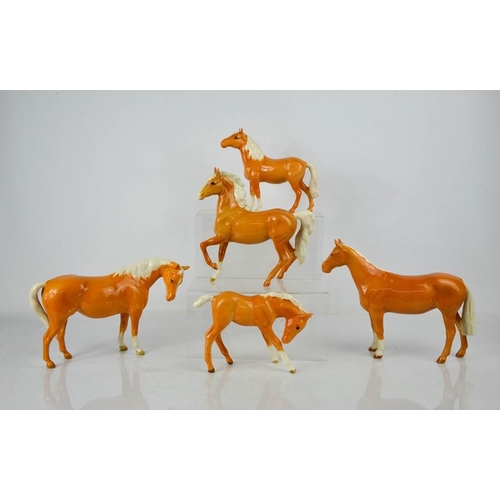 143 - Five Beswick porcelain Palomino horses in various poses, tallest 17cm high.