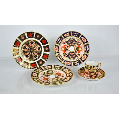 53 - A group of Royal Crown Derby porcelain to include three plates; 1128, 2451 and 2451, and a coffee ca... 