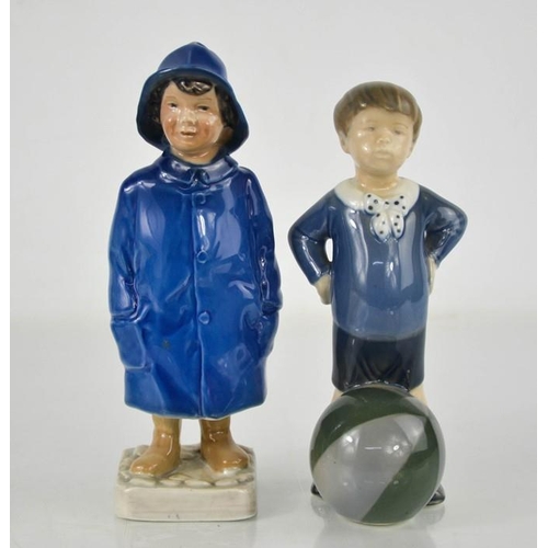 64 - A Royal Copenhagen child in a blue raincoat numbered 532 to the base, together with a Denmark boy wi... 