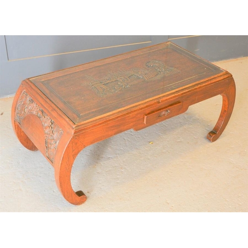 672 - A Chinese carved coffee table, with figural scene to top, single drawer to front, 42cm high by 96cm ... 