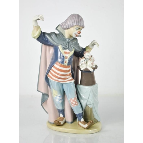 69 - A Lladro clown, standing beside a magic hat with kittens, 5892, 28cm high.