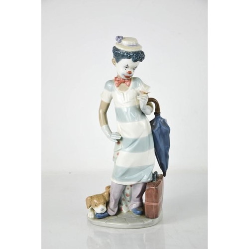 70 - A Lladro clown, holding an umbrella with puppy at his feet, 5838, 28cm high.