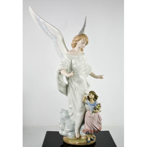 91 - A large Lladro figurine titled Guardian Angel, a winged angel standing guard over a young girl, crea... 