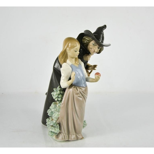 99 - A Lladro porcelain figure group titled Snow White, Witch and the Apple, 5067, 27cm high.