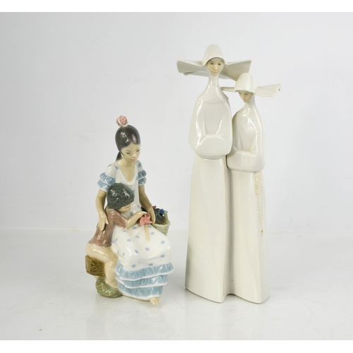 138 - Two Lladro porcelain figurines: Gypsy Girl with Boy, and Nuns in White number 4611, 34cm high.