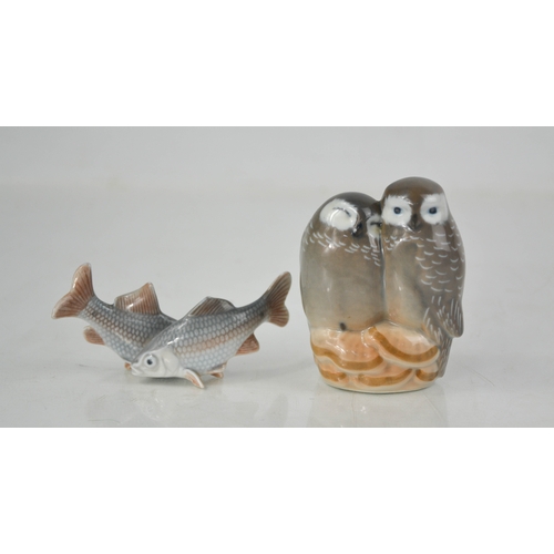 140 - A Royal Copenhagen pair of porcelain Owls numbered 834, and a pair of Denmark fish number 2870.