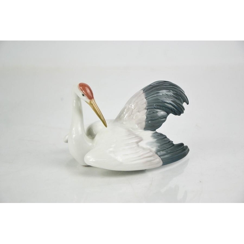 104 - A Lladro porcelain Fluttering Crane, signed to the base Lladro, and dated 27.4.90, no. 1599, 8cm hig... 