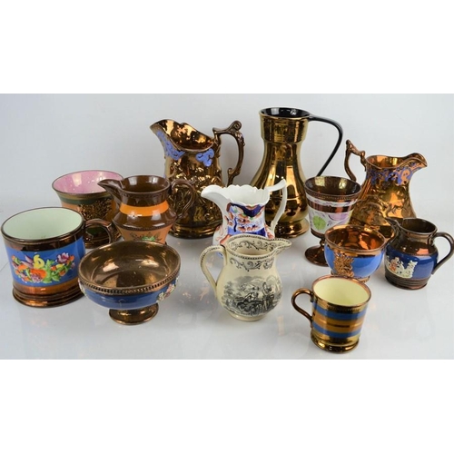 118 - A quantity of Victorian lustre ware to include jugs tankards and goblets and a black and white milk ... 