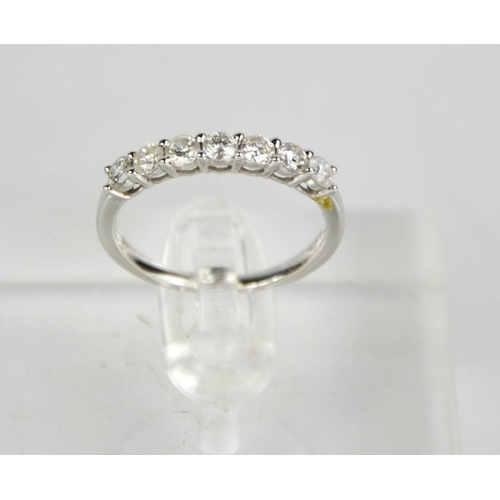 144 - A 9ct white gold and diamond seven stone ring, 0.62ct total diamond weight, size M, 2g.