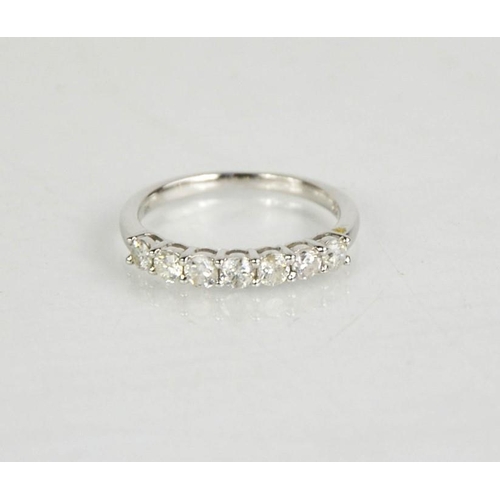 144 - A 9ct white gold and diamond seven stone ring, 0.62ct total diamond weight, size M, 2g.