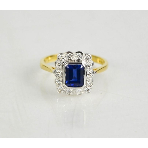 157 - An 18ct yellow and white gold, sapphire (1.10ct) and diamond (0.48ct)  ring, size O, 4.1g.