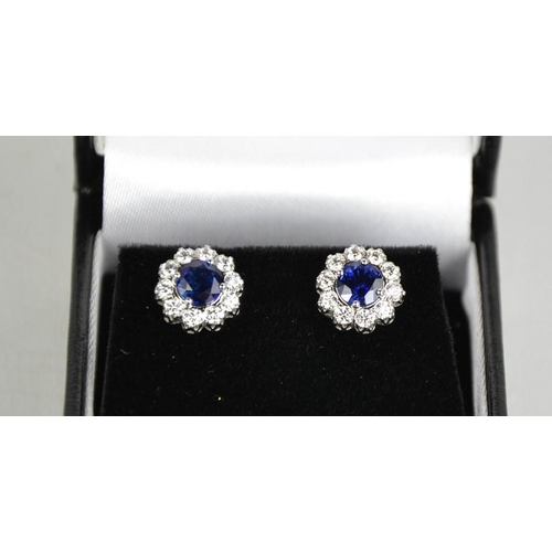 158 - A pair of 18ct white gold, blue sapphire and diamond cluster earrings, the sapphires totalling 1.2ct... 