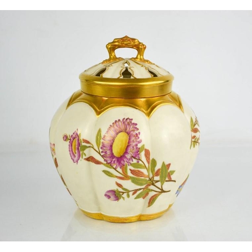 17 - A Royal Worcester pot pourri vase with inner cover and outer cover painted with flowers, on an ivory... 