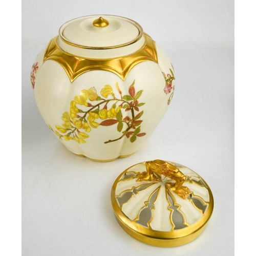 17 - A Royal Worcester pot pourri vase with inner cover and outer cover painted with flowers, on an ivory... 