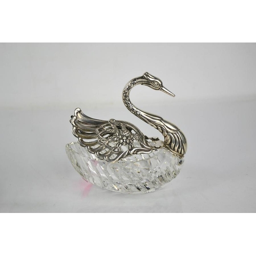 224 - A white metal and cut crystal dish in the form of a swan, stamped 825, the pierced and embossed wing... 