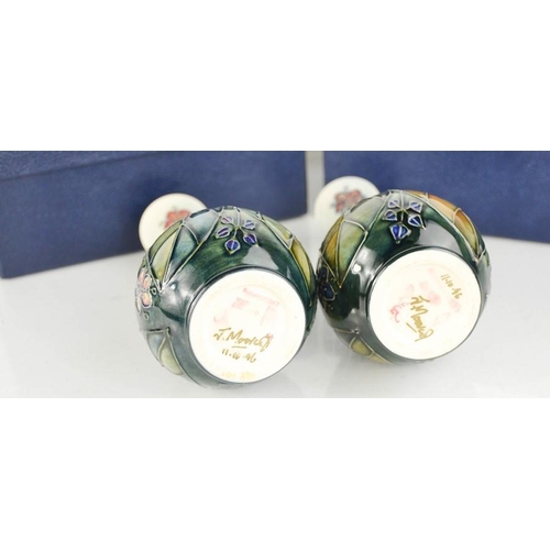 32 - A pair of Moorcroft vases, with the original boxes, signed J Moorcroft to the bases.