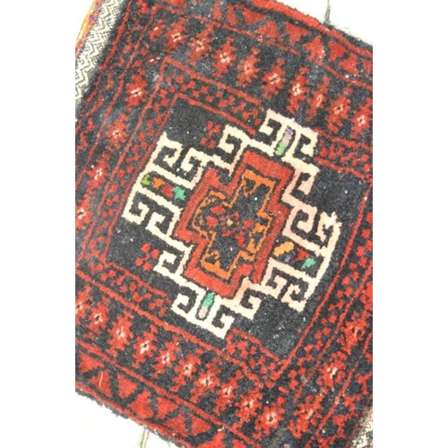 562 - An Afganistan Belouch bag with red ground, 1ft2 by 1ft2ins, together with another with brown ground ... 