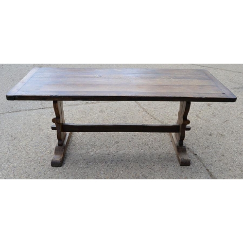 566 - An oak refrectory table, the planked top with cleated ends, raised on lyre form legs and central str... 