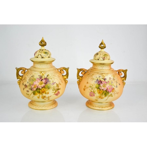 6 - A pair of Royal Worcester peach and ivory ground bulbous vase and covers painted with flowers with t... 