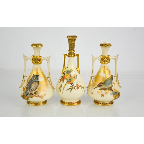 9 - A garniture of three Royal Worcester twin handled vases, of Persian design, painted with birds on an... 