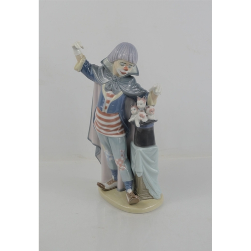 91 - A Lladro clown, standing beside a magic hat with kittens, 5892, 28cm high.