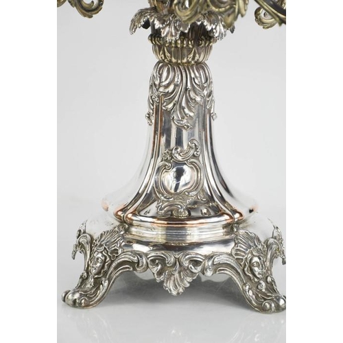 116 - An impressive 19th century silver plated centrepiece with four scrollwork removable branches raising... 