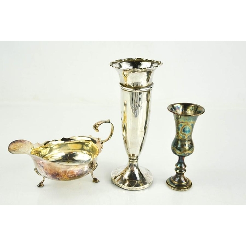 128 - A silver bud vase with weighted base, a silver vase engraved with inscription, and silver sauce boat... 