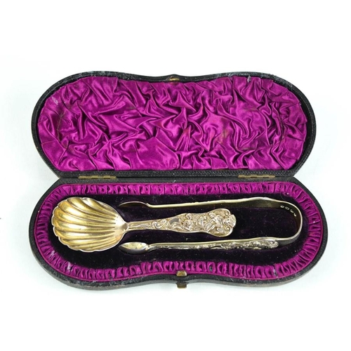 144 - A silver caddy spoon and sugar nip set, embossed with mythological scene, bearing residual gilding, ... 