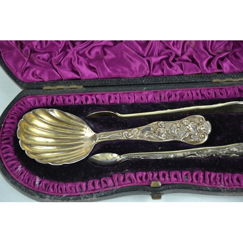 144 - A silver caddy spoon and sugar nip set, embossed with mythological scene, bearing residual gilding, ... 