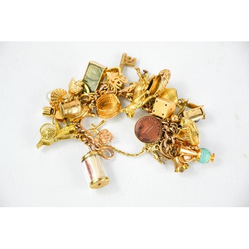 170 - A 9ct gold charm bracelet, 97g.